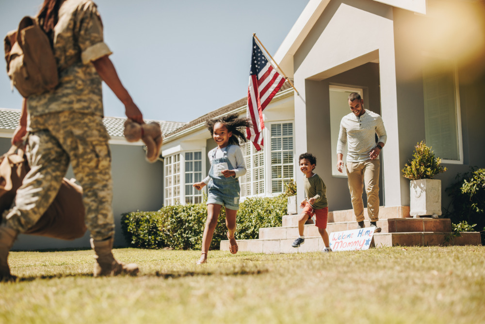 Movers helping a military family move into their new home during a PCS relocation