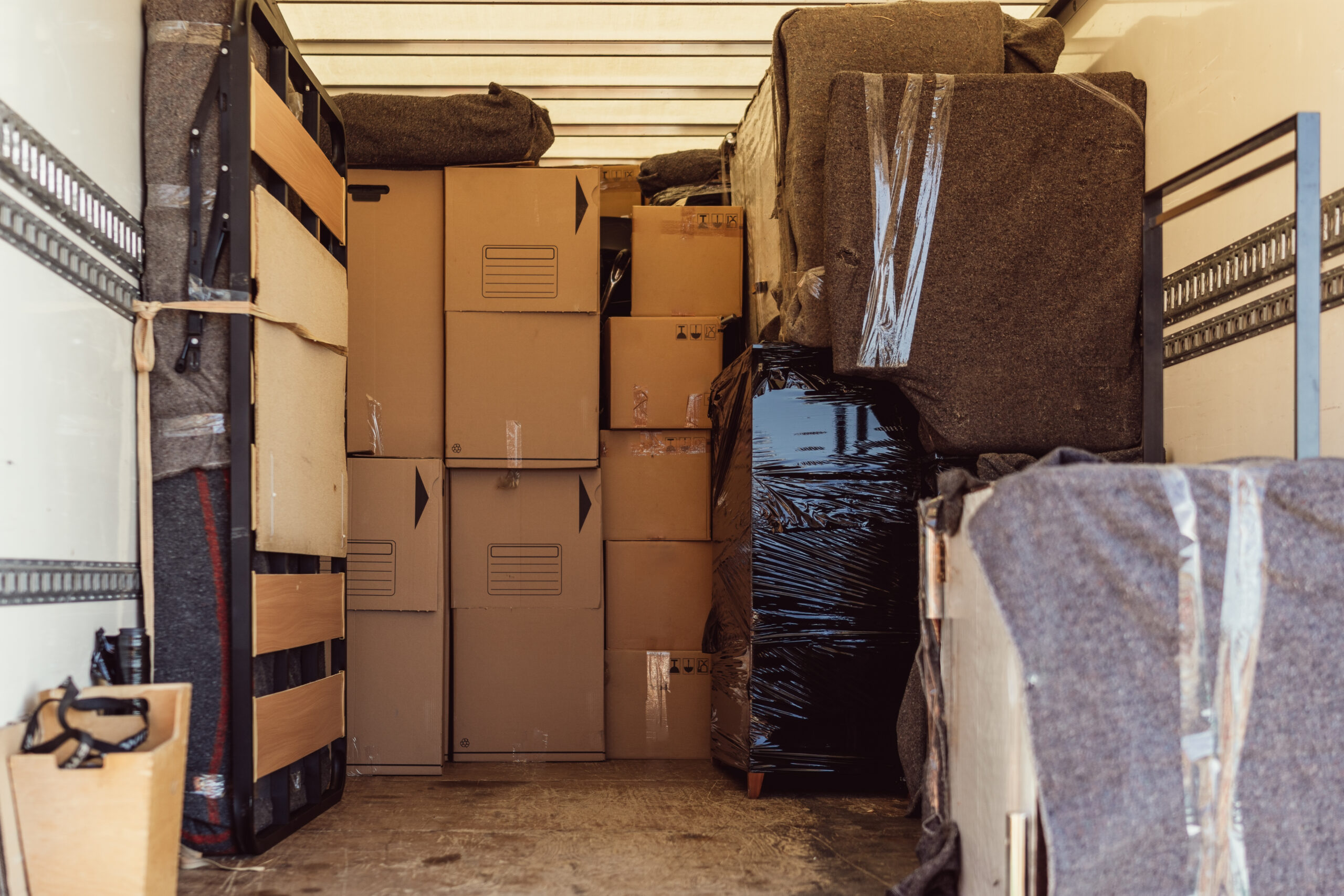Moving truck packed with boxes and wrapped furniture by Moving With Prince